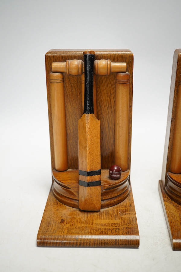 A pair of oak cricket 'bat, ball and stumps' book ends, handmade by Thornton Smith Company, c.1930, 18cm high. Condition - good